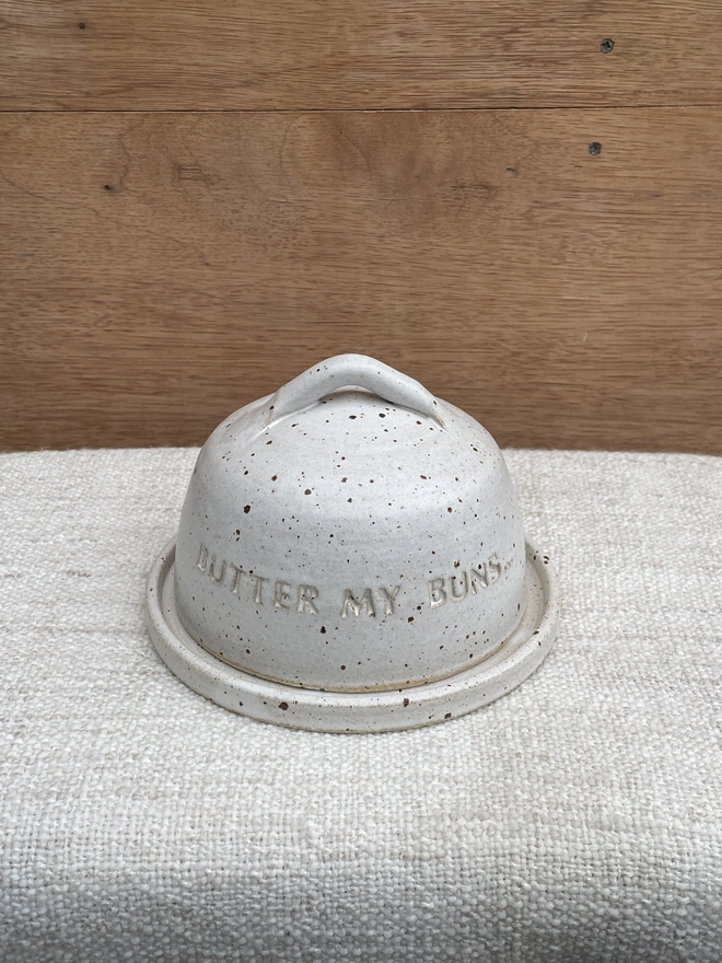 butter dish with 'butter my buns' written on it