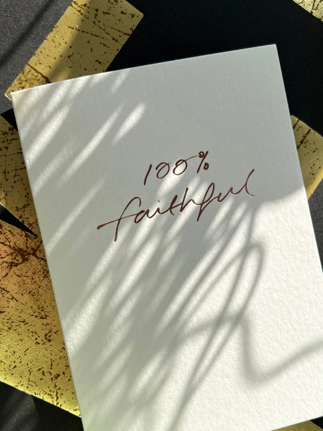 handfoiled luxury card that has 100% faithful written on the front stamped in rose gold foil - inspired by the hit BBC show The Traitors