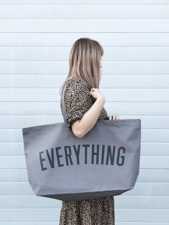 Model carrying the Everything oversized tote bag in grey canvas