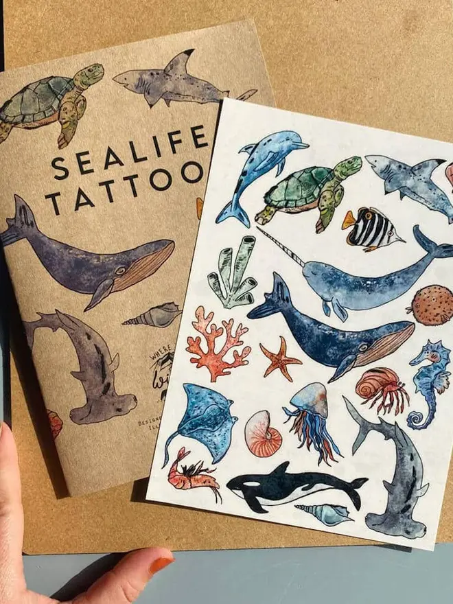 Animal Temporary Tattoos, a "SEALIFE TATTOO" booklet sits next to a sheet of colourful ocean animal temporary tattoos.