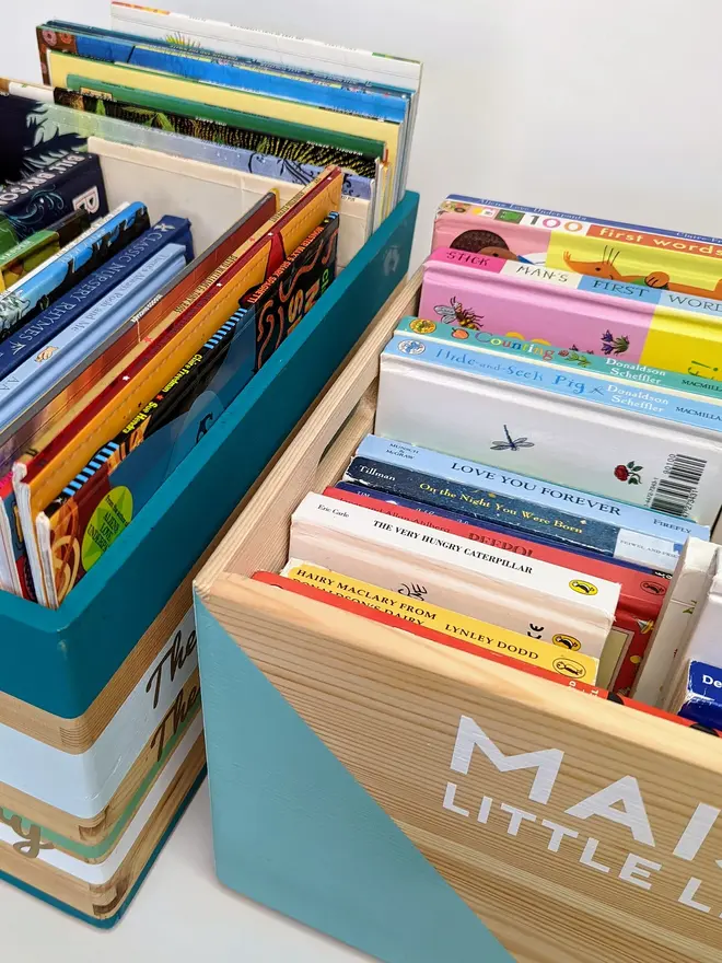 personalised kids' book storage box. two personalised wooden book boxes full of books.
