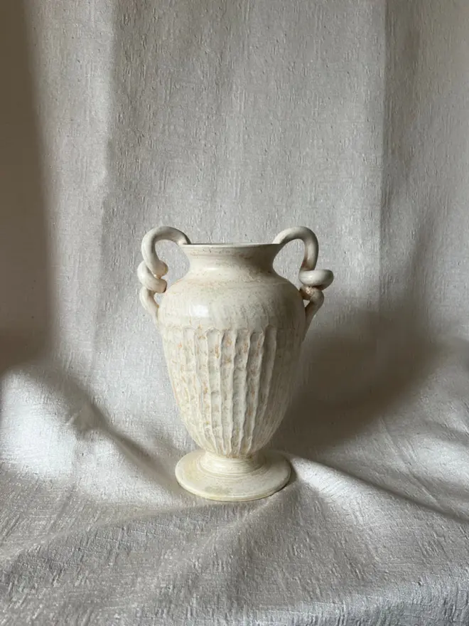 Urn Vase on white cloth background
