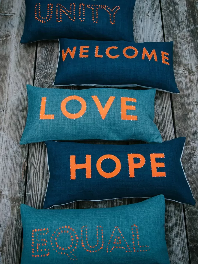 A collection of Love Welcomes Cushions.