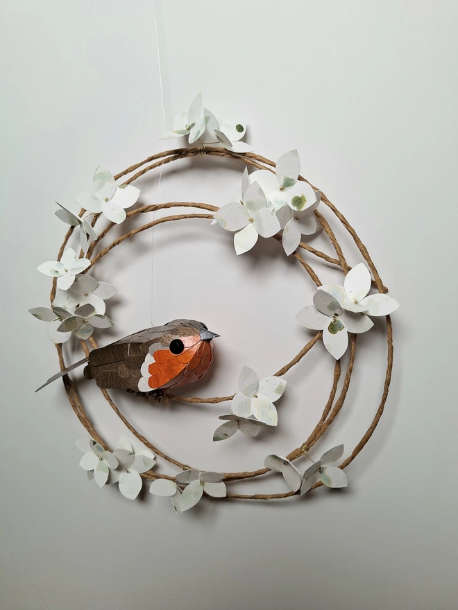 floral wreath featuring a robin bird sculpture