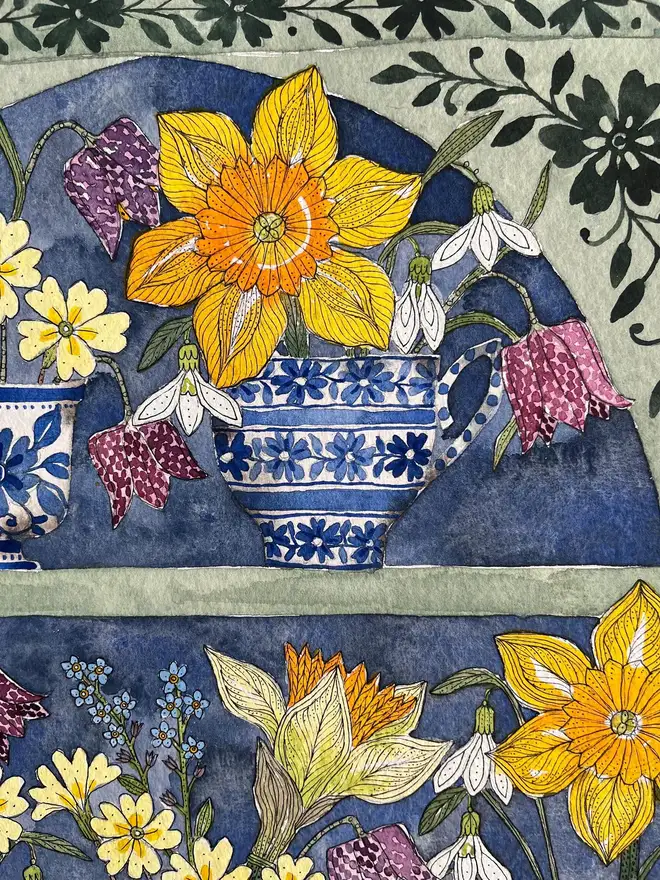 daffodils, snowdrops and spring flowers in delftware teacups displayed in a plant theatre