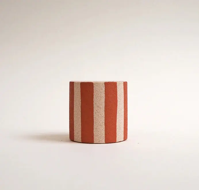 Mini Stripy Plant Pot. A white ceramic pot with vertical coloured stripes set against a plain light background.