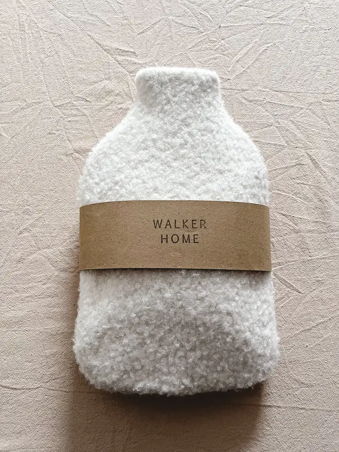 hot water bottle with white wool cover