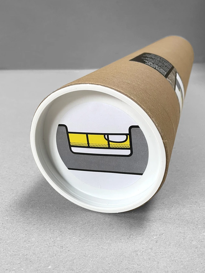 The spirit level print in a tube, with a sticker on the lid at one end. Laid in a light grey studio background.