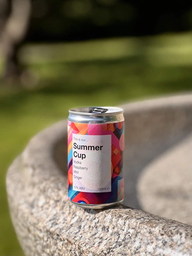 Can of Summer Cup shown outside, in a park