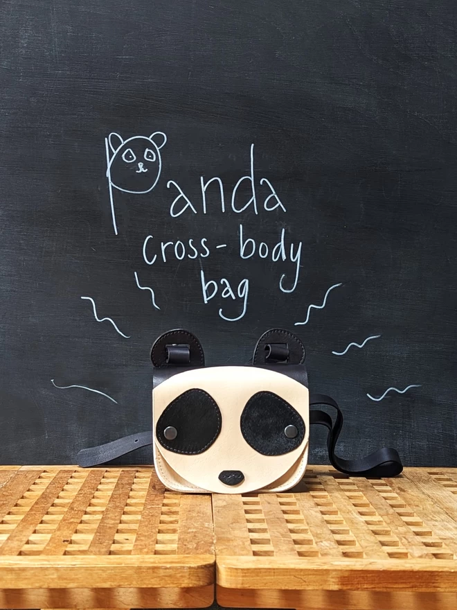 Handmade leather Panda cross- body bag, viewed from the front. 
