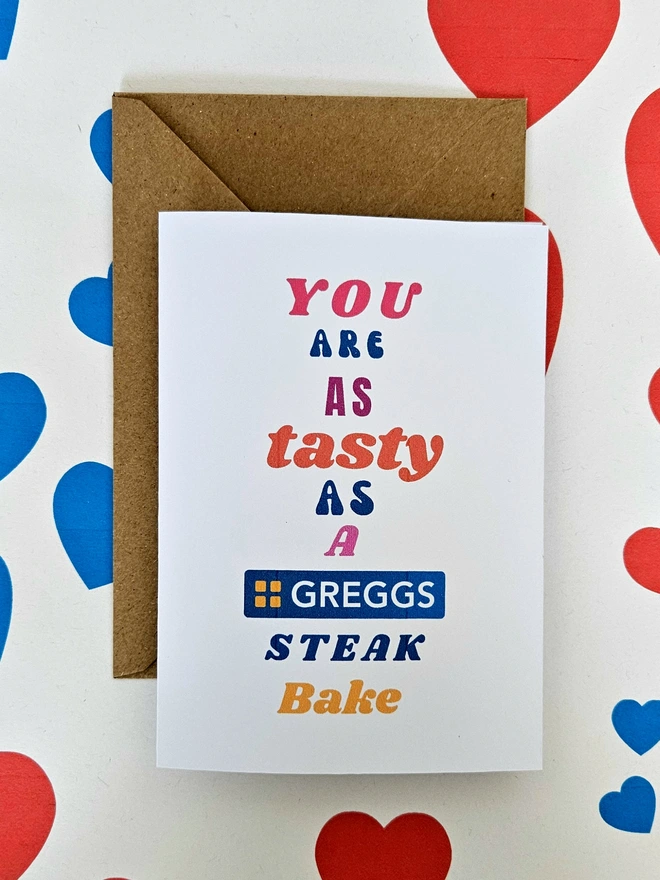 A humorous valentine greeting card that says you are as tasty as a Greggs Steak Bake in colourful text in different fonts