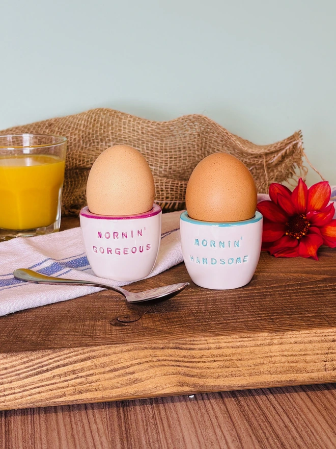 Pair of handmade ceramic egg cups with the lettering Mornin Handsome and Mornin Gorgeous