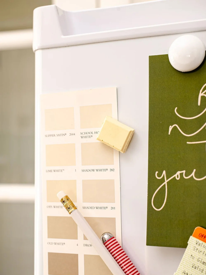 ceramic chocolate magets. a white chocolate magnet on a fridge door.