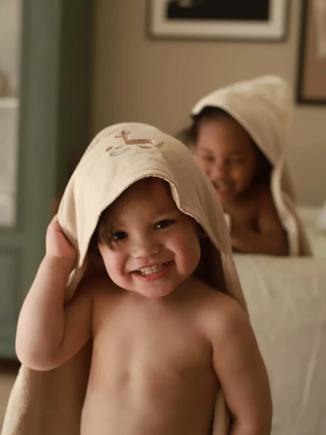 Babies wearing the hooded towel for bath time
