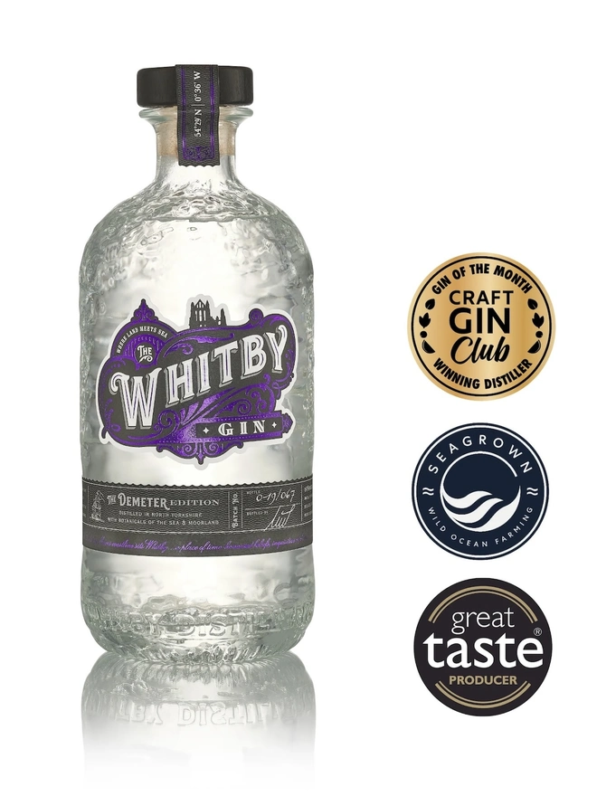 The Demeter Edition Gin, a bottle of gin sitting on a plain white surface. 