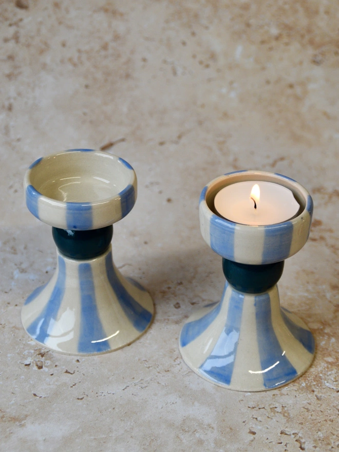 Pair of handmade striped ceramic candlestick holders in blue and cream tones