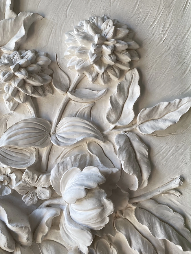 Detail of plaster sculpture with flower design with Dahlias and Roses