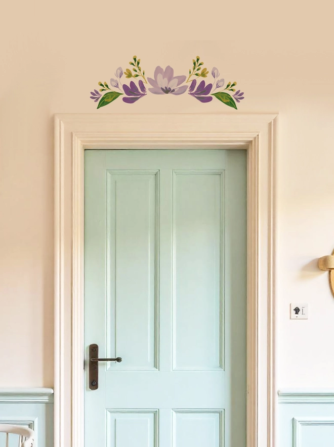 Internal door with an elegant floral wall sticker  / decal positioned above the door in different shades of purple, handpainted floral wall sticker 