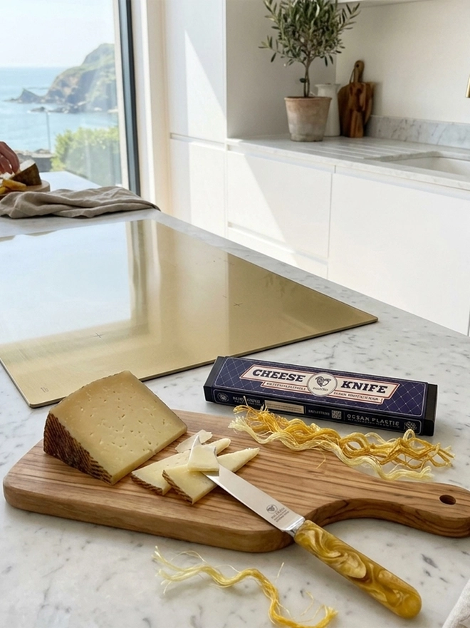 Sustainable kitchen cheese knife made from recovered fishing nets, combining beautiful design with positive environmental impact.