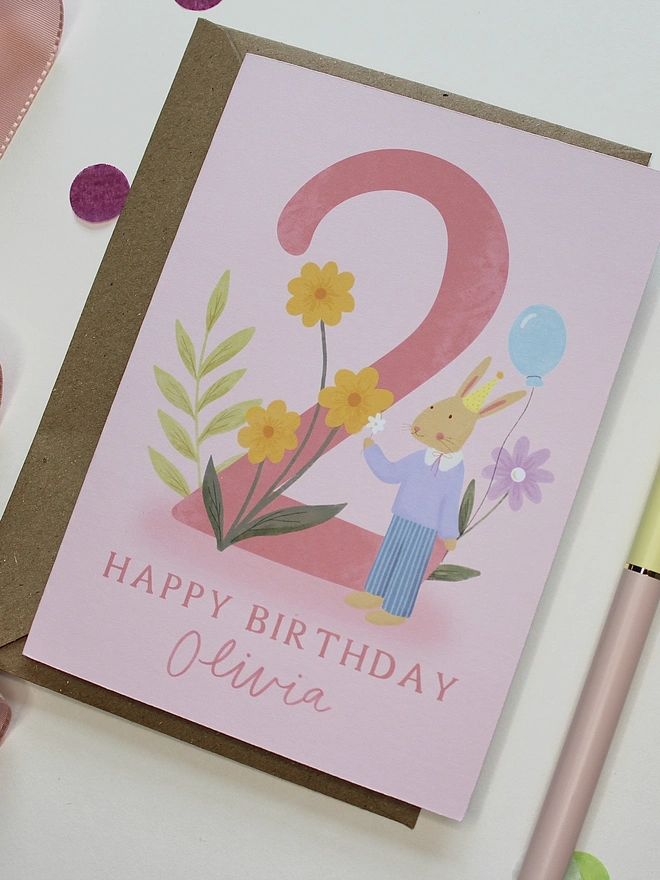 personalised floral 2nd birthday card. pink 2nd birthday card with illustrated rabbit and flowers.