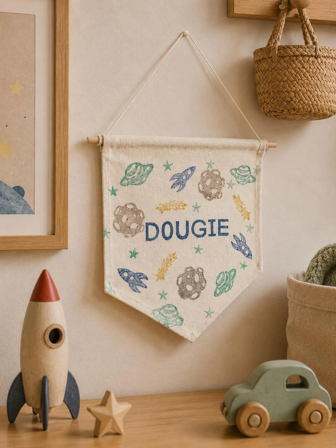 personalised space cotton wall hanging. a cotton banner on a bedroom wall.