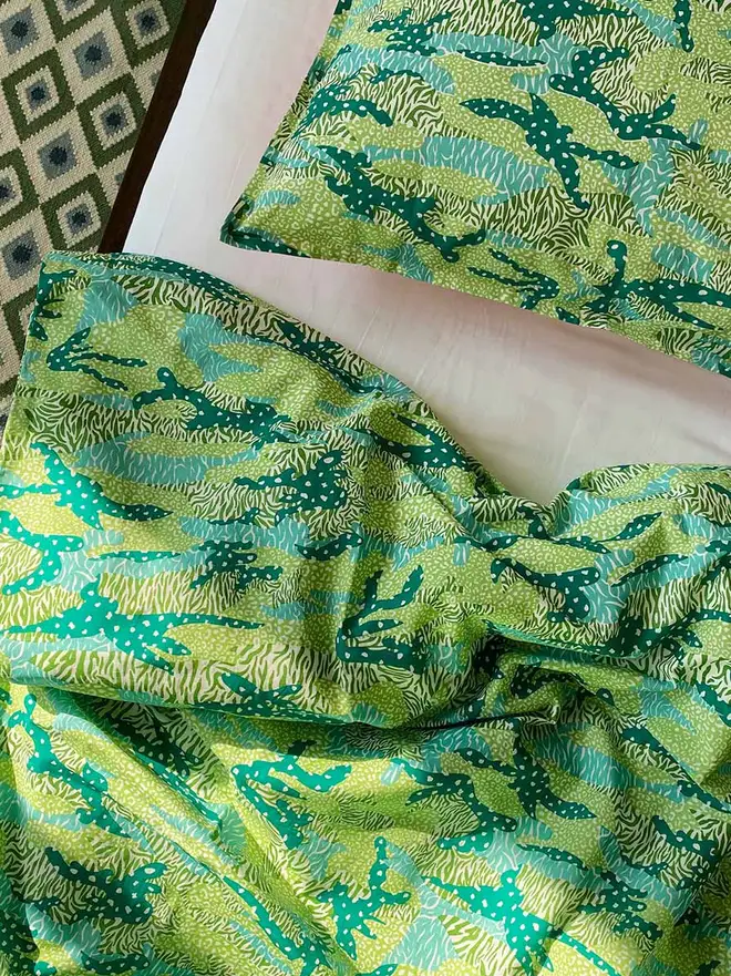 Green Big Cat Camo Duvet Cover And Pillowcase, a green duvet and pillowcase sitting on a bed. 