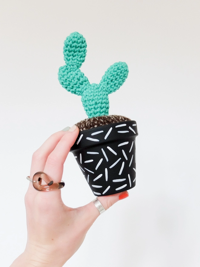 Crocheted cactus in hand-painted pot with dash design