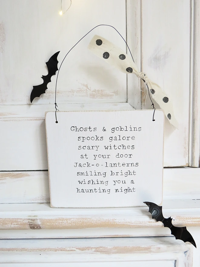 hand painted wooden sign with ghosts and goblins rhyme and spotty ribbon detail