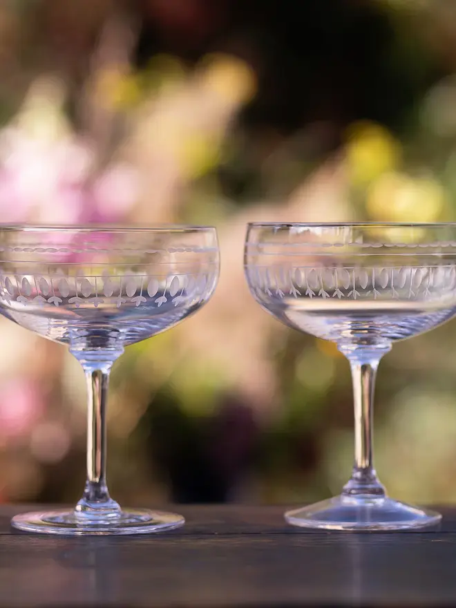 engraved oval crystal cocktail glasses. two cocktail glasses with a detailed oval pattern.