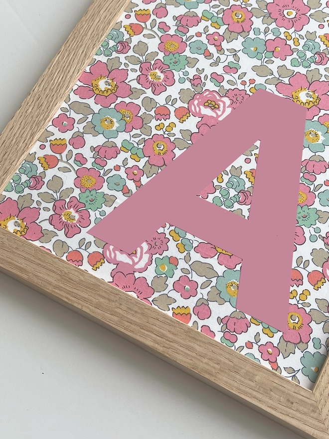Personalised framed pink initial on Liberty Betsy pink fabric - close up