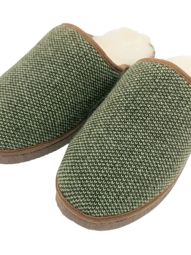 Lambswool & Sheepskin Slippers, a pair of colourful lambswool and sheepskin slippers sitting on a plain white surface. 