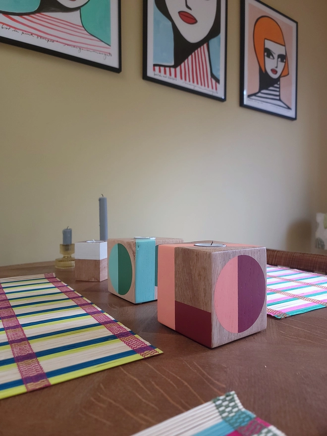 HOPE and LOVE painted wood cube candles on table with colourful table mats and wall art