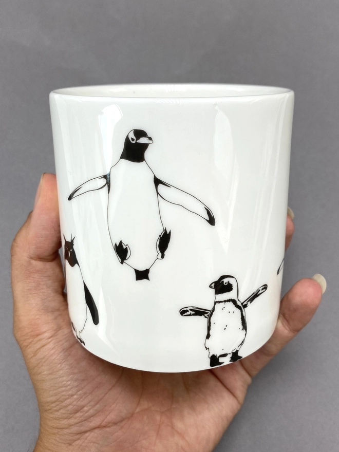 Jumping Gentoo and African penguin screen printed decal on the mutli penguin mug