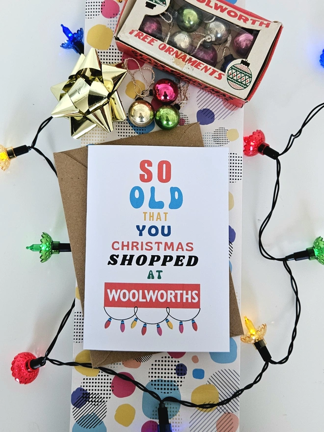 Card that says so old you Christmas shopped at Woolworths with retro fairy lights around it