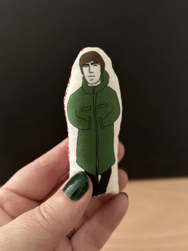 Mini illustrated fabric dolls of Oasis frontman Liam Gallagher.