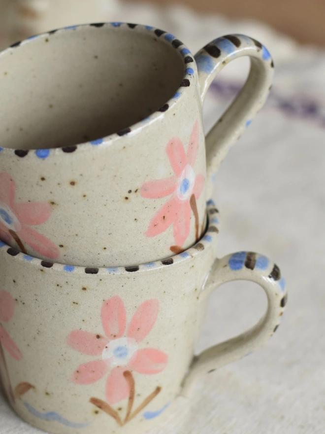 Handmade ceramic pottery mug with floral pattern