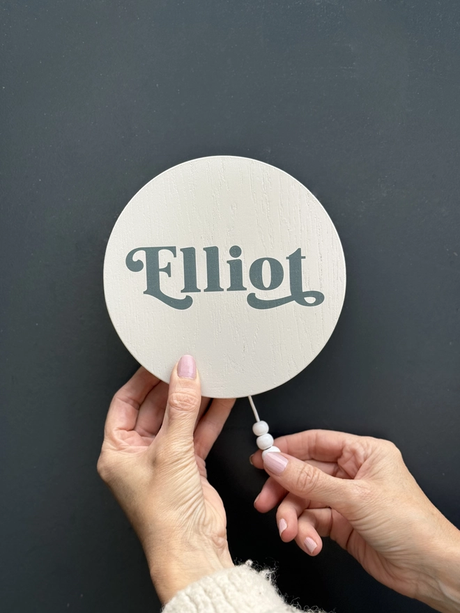 musical wall hanging with the name elliot in a swirly font printed on