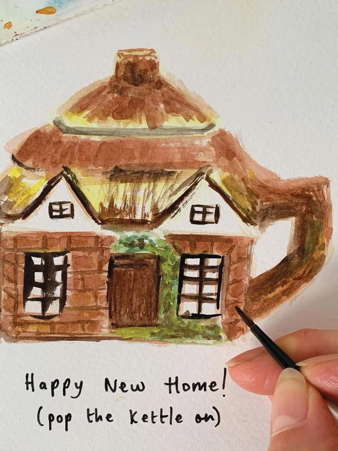 Close up shot of the original, watercolour illustration for the Happy New Home Cottage Teapot Card