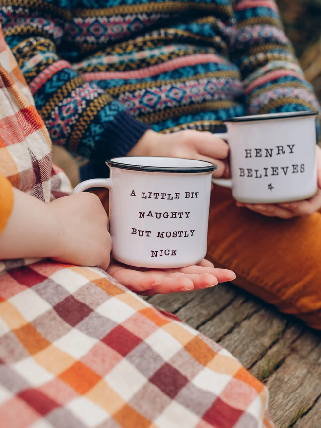 children holding christmas ceramic mugs