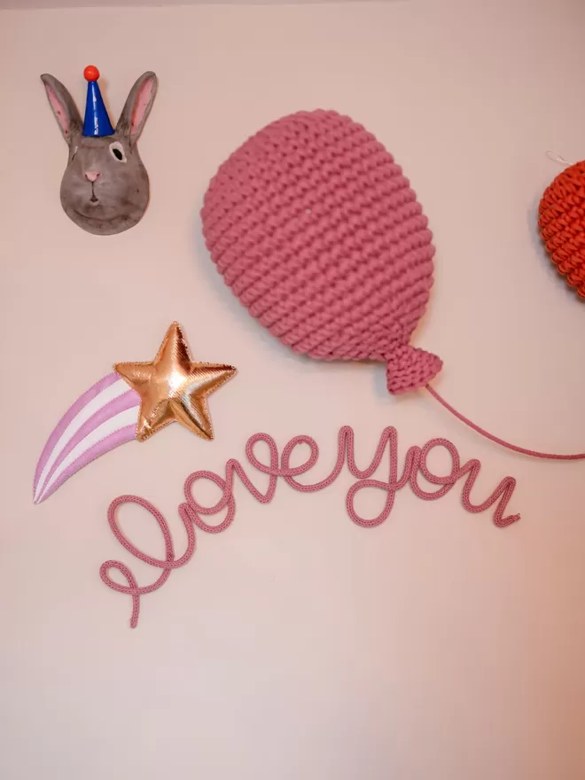 "I love you" wall art sign hanging up in a nursery, for a newborn baby. 