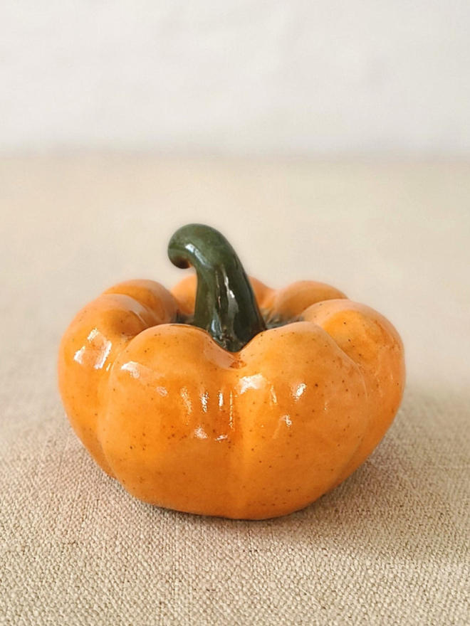 classic medium pumpkin. a painted orange ceramic pumpkin.