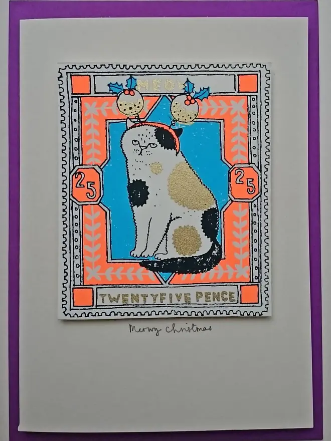 Cat Christmas Card Christmas Puds, a white card with a colourful cat design in the centre, on a purple envelope. 