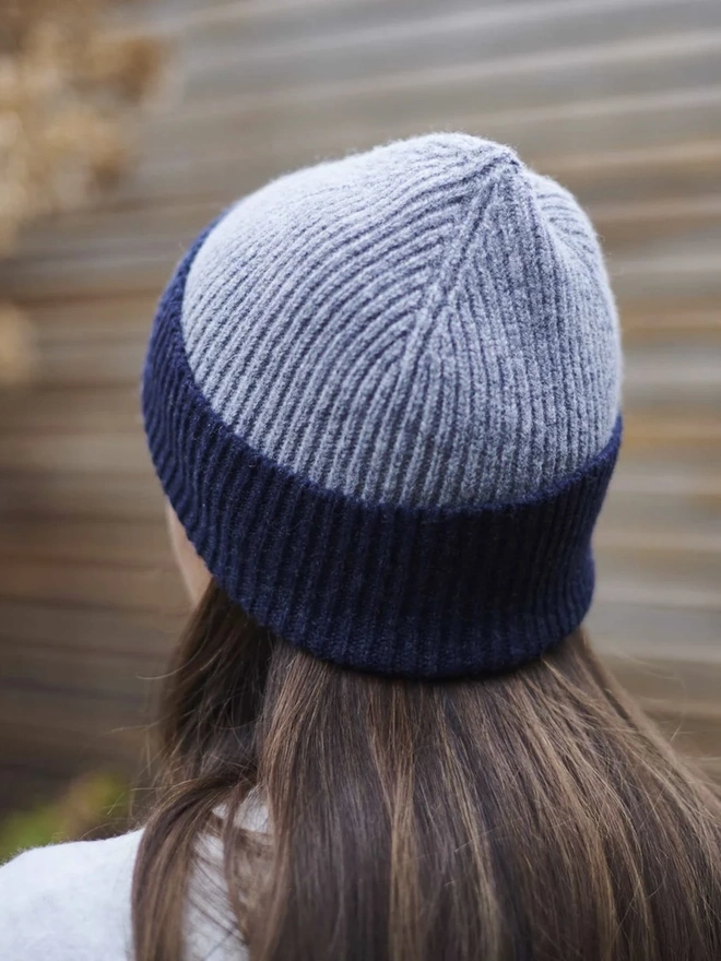 Ribbed Lambswool Women's Beanie, a woman wearing a colourful beanie outdoors. 