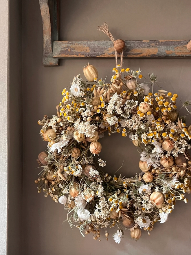 Autumnal Wreath. A wreath made of dried autumnal flowers, hung on a wall.