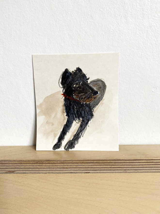 painted portrait of pet dog on shelf 