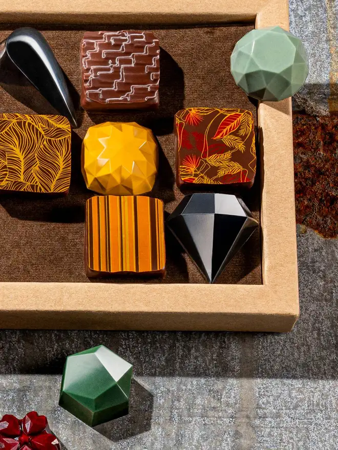 chocolates close up, green, black diamond, yellow and square pralines