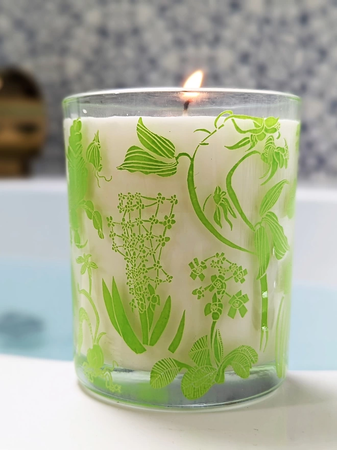 laura's floral, wild fig & grape charity candle in a reusable glass with bright green illustrations