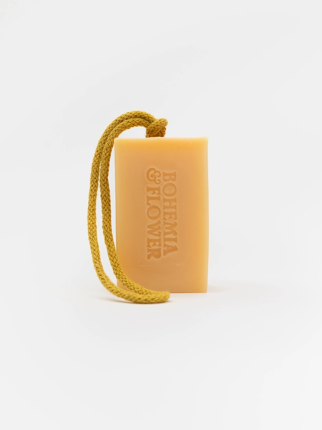 Close-up of Grove Soap on a Rope showing calendula petals and natural yellow colour, handmade in small batches in the UK.