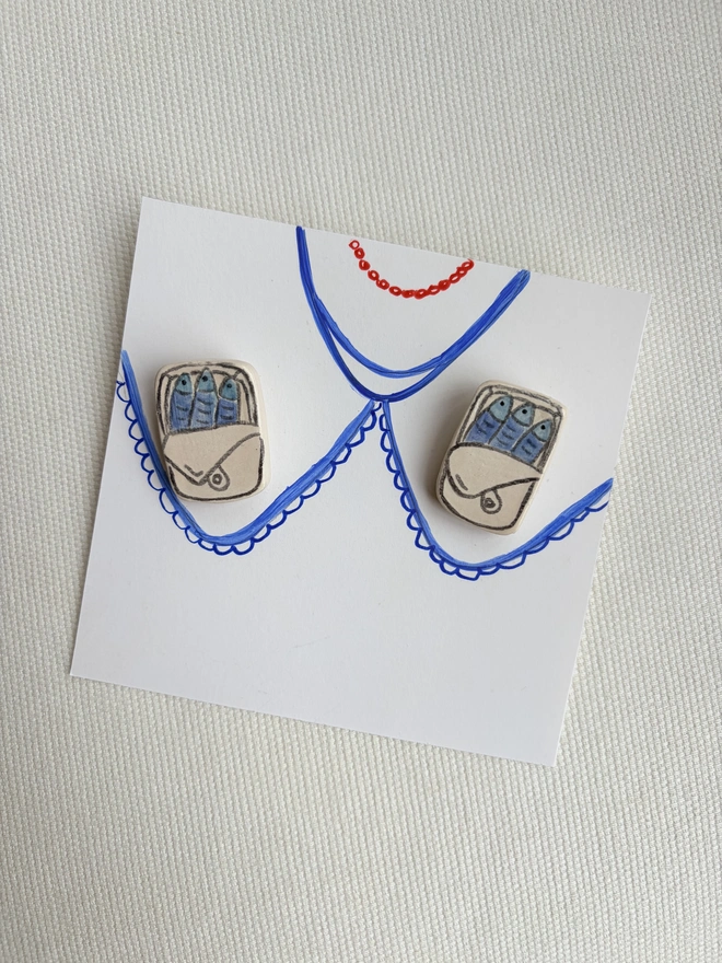 Foodie collar pins. A pair of sardine tin collar pins on a collar hand-sketched on paper