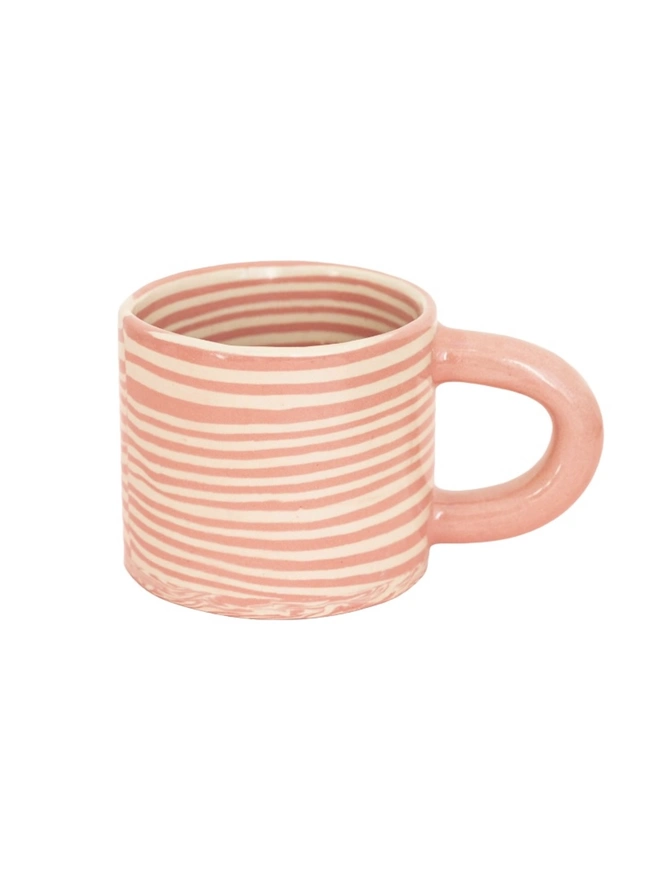 Pink Striped Mug, a pink striped mug sitting on a plain surface against a white backdrop. 